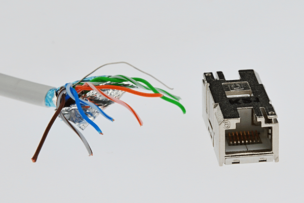 Cat6 SMTP wire with spread ends close to female LAN Cat6 connector in steel chassis