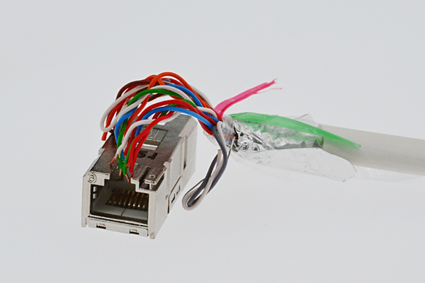 Cat6 SMTP shaped like hand holds female LAN Cat6 connector in steel chassis
